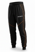 Velocity loose-fit athletic pants in black with orange geometric pattern and VELOCITY text